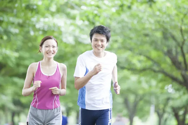 Sporty Asian Couple Jogging Park — Stock Photo, Image