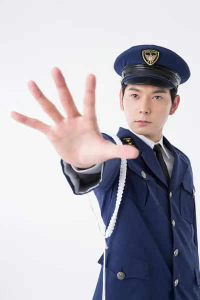 asian police officer showing stop sign