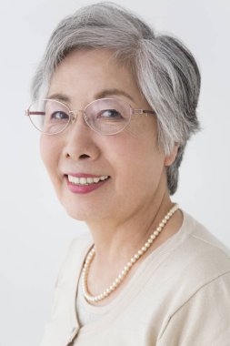 Gözlüklü son sınıf öğrencisi gülümsüyor. 