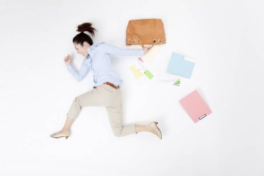 Dağınık ofis malzemeleriyle yatan kadın.