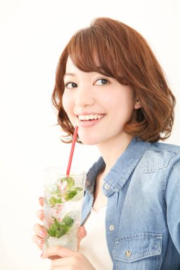 Güzel Japon kadın naneli ferahlatıcı soğuk içecek içiyor.