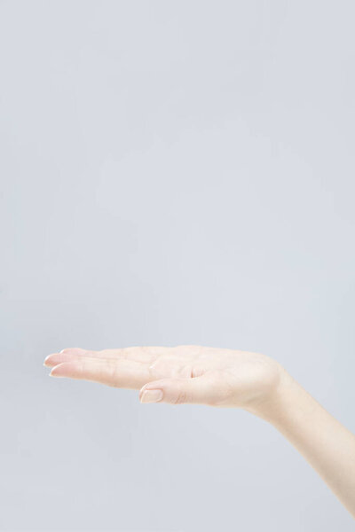 Closeup of female hand gesturing on white background 
