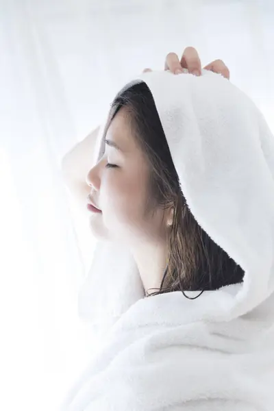 young beautiful asian woman in the bath with white towel