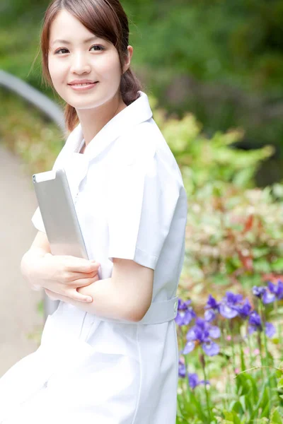 young woman with a tablet  in the park
