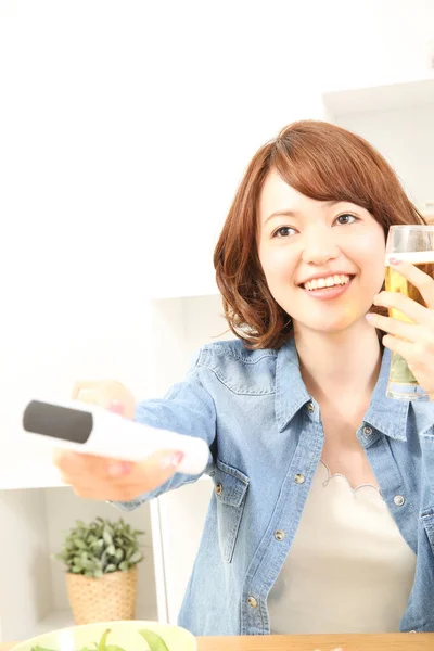 Radosna Japonka Pijąca Piwo Podczas Oglądania Telewizji Trzymanie Pilota Ręku — Zdjęcie stockowe