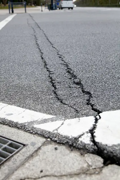 cracked asphalt road surface after earthquake