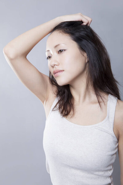 Studio shot of beautiful young Asian woman