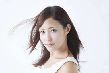 Genç, güzel Asyalı kadın izole edilmiş arka planda kameraya bakıyor.  