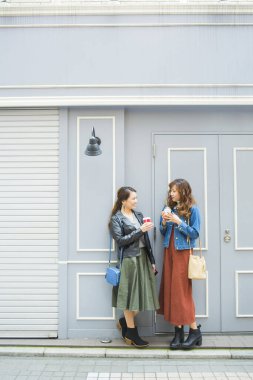 Şehirde kahveli iki genç kadın.