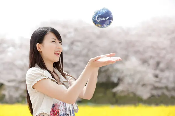 young Japanese woman with world globe