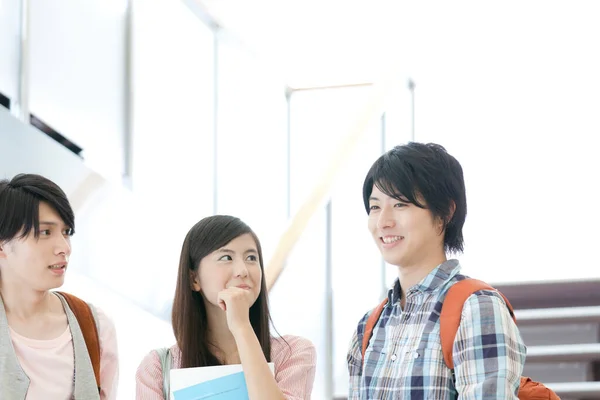 cheerful young Japanese students at university