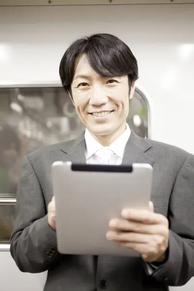 Asian Man Tablet Train — Stock Photo, Image