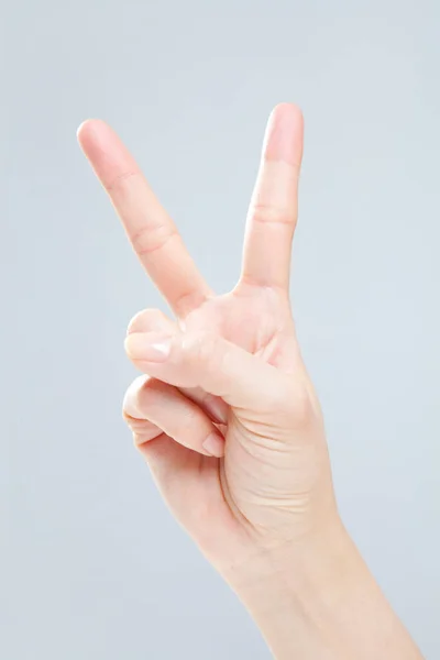 Closeup of female hand gesturing on white background