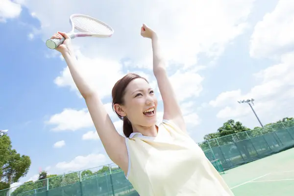 woman playing tennis  in summer