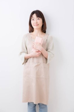 Güzel Japon kadın beyaz arka planda cüzdanı tutuyor.