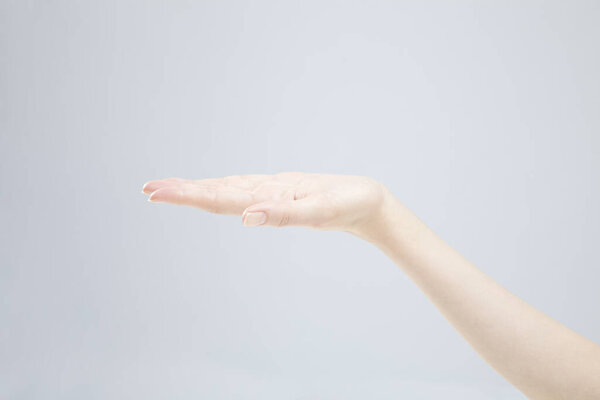 Closeup of female hand gesturing on white background 