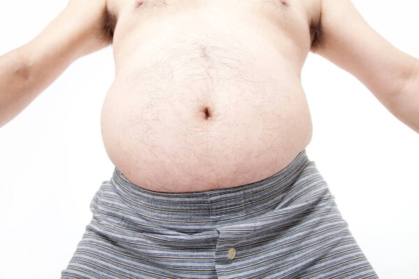 Fat man in underwear shows fat deposits in abdomen. Concept of not proper nutrition, sedentary lifestyle 