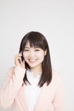 beyaz zemin üzerinde telefon olan kadın