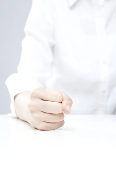 Closeup of female hand gesturing on white background