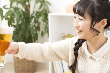Genç bayan evde bira içiyor, şerefe.