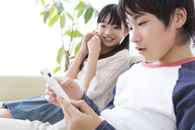 Asyalı çocuklar akıllı telefon kullanıyor.