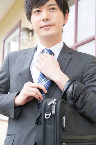 asian businessman with briefcase outdoors
