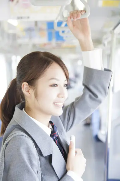 Smiling Asian Student Wearing School Uniform Holding Smartphone While Traveling — Stock Photo, Image