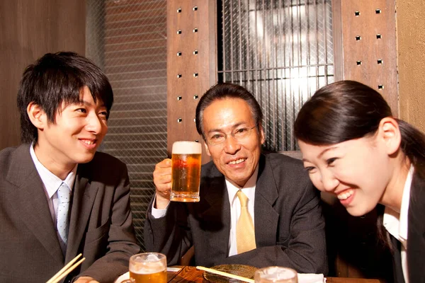 Group of Japanese people sitting at beer pub