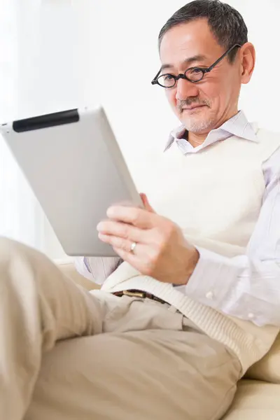 senior man using digital tablet