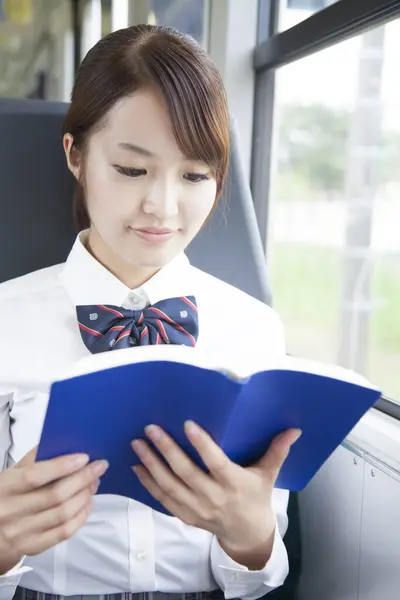 Young Asian Woman Student Reading Book Public Transport — Stockfoto