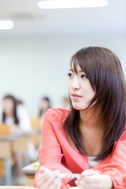 Genç Asyalı kız öğrenci sınıfta. 