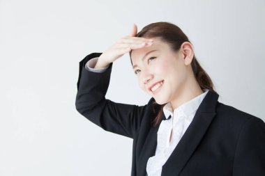 Uzaktaki takım elbiseli Asyalı genç bir iş kadını. 