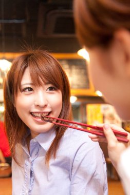 Erkek arkadaşı kadınını yemek çubuklarıyla besliyor.