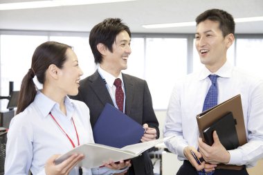 Bir grup genç Japon iş adamı projeyi tartışıyor. takım çalışması konsepti