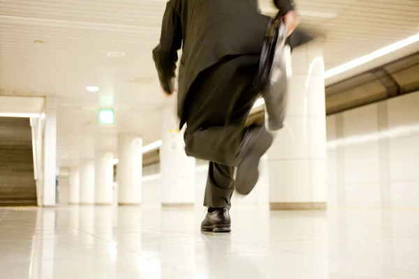 businessman with bag running in subway