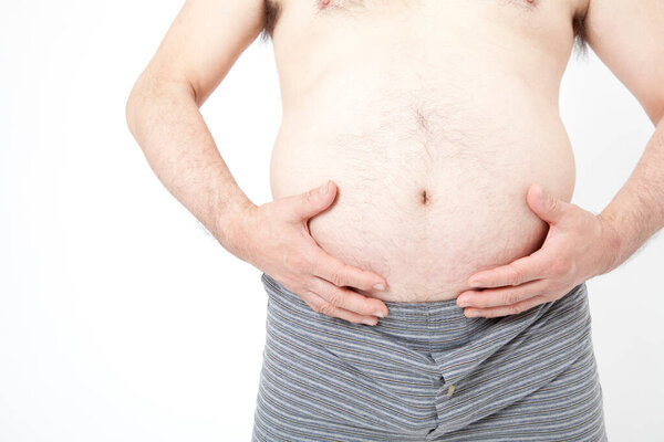 Fat man in underwear shows fat deposits in abdomen. Concept of not proper nutrition, sedentary lifestyle