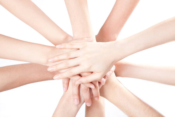 close up view of people holding hands together on white background