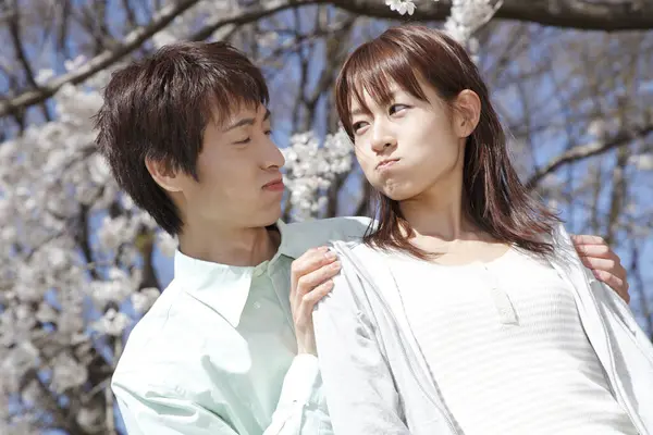 young japanese couple in spring park