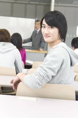 Bir grup öğrenci ders sırasında oturuyor. Eğitim kavramı