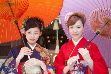 Şemsiyeli kimono giyen güzel Japon kızları. 