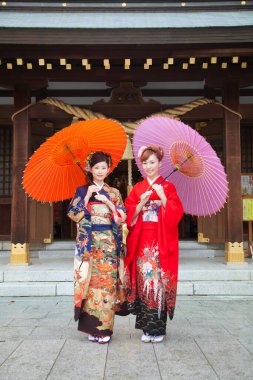 Şemsiyeli kimono giyen güzel Japon kızları. 