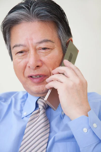 Asian Senior Business Man Using Mobile Phone Royalty Free Stock Images