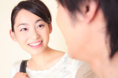 Beyaz arka planda mutlu Asyalı çiftin yakın plan portresi.