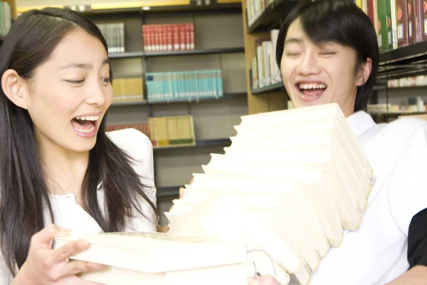 在图书馆里快乐的年轻日本学生 — 图库照片