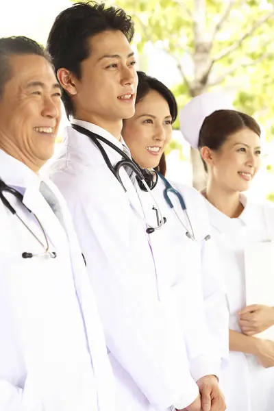Japanese medical staff standing near hospital