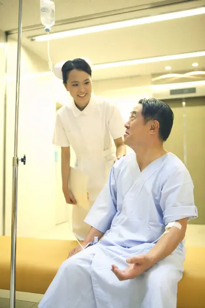 senior asian man with nurse at hospital