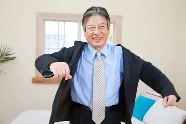Senior Asian Man Smiling Camera Putting Jacket Stock Picture