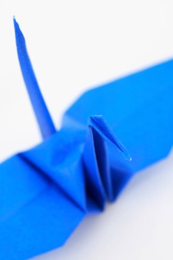 Beyaz arkaplanda mavi kağıt origami vinç