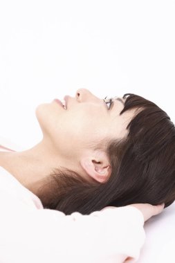 Genç Asin kadın yatakta yatıyor.