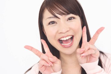 Young Japanese woman showing victory signs